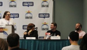 Sam Saturday speaking while panelists look on