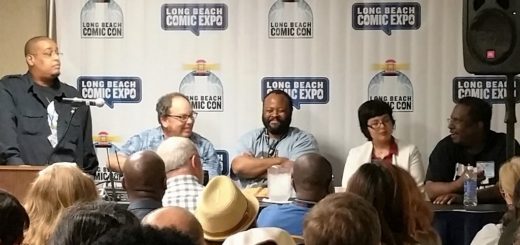 Campbell speaking while panelists look on